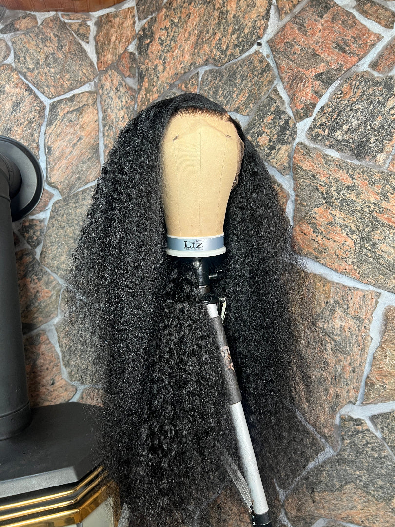 Black curly wig on a mannequin 
