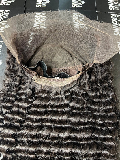 A close-up image of a natural black lace human hair wig with deep wave texture.