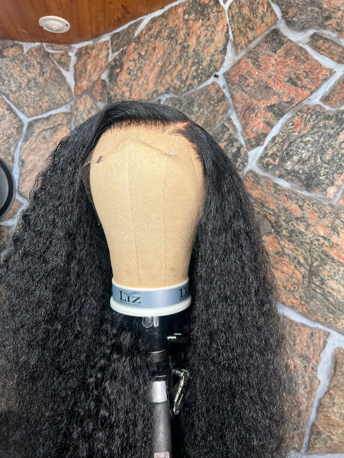Black curly wig on a mannequin 