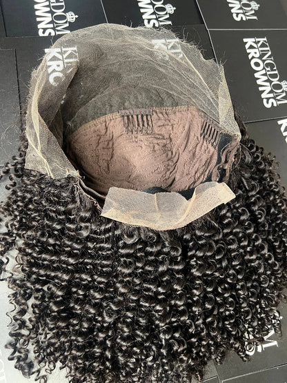 A close-up image of a natural black lace human hair wig with deep wave texture.