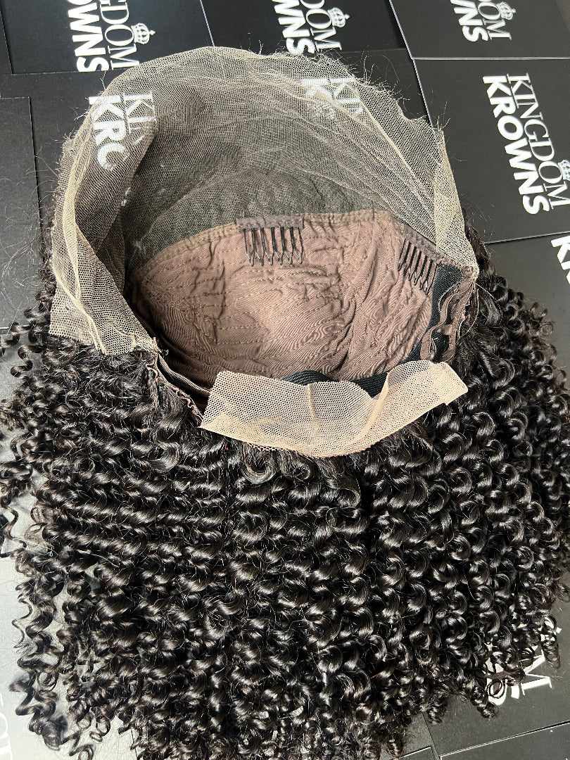 A close-up image of a natural black lace human hair wig with deep wave texture.