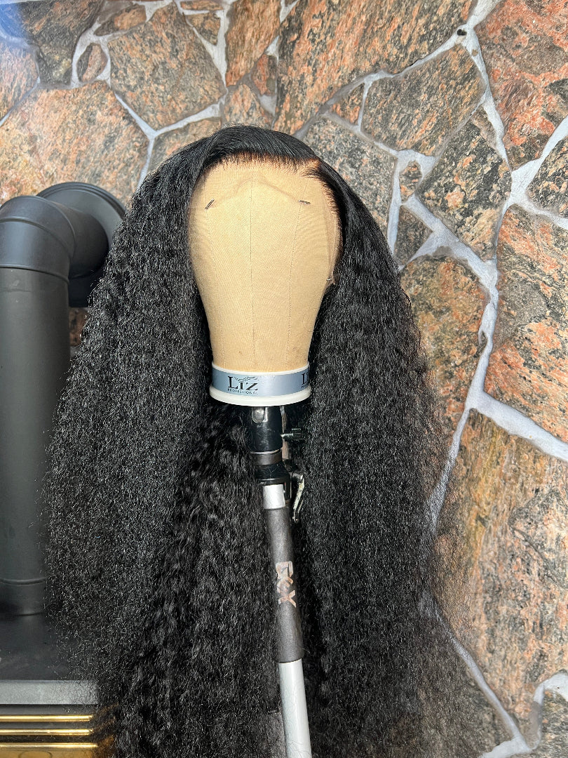 Black curly wig on a mannequin 