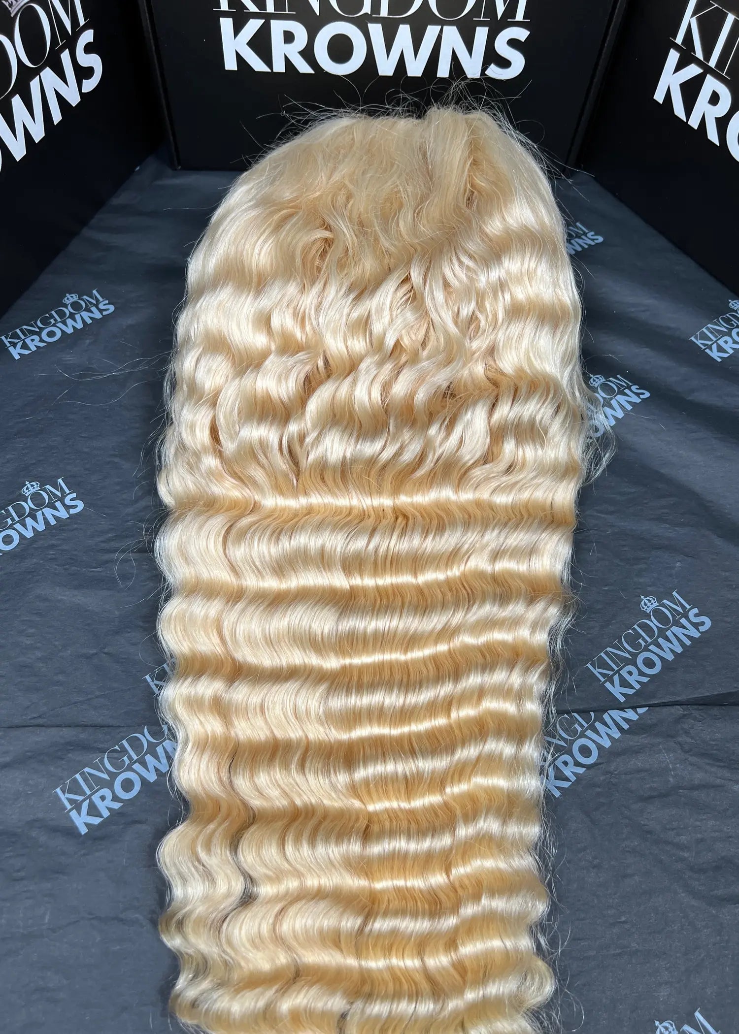 Blonde hair extensions on a branded surface