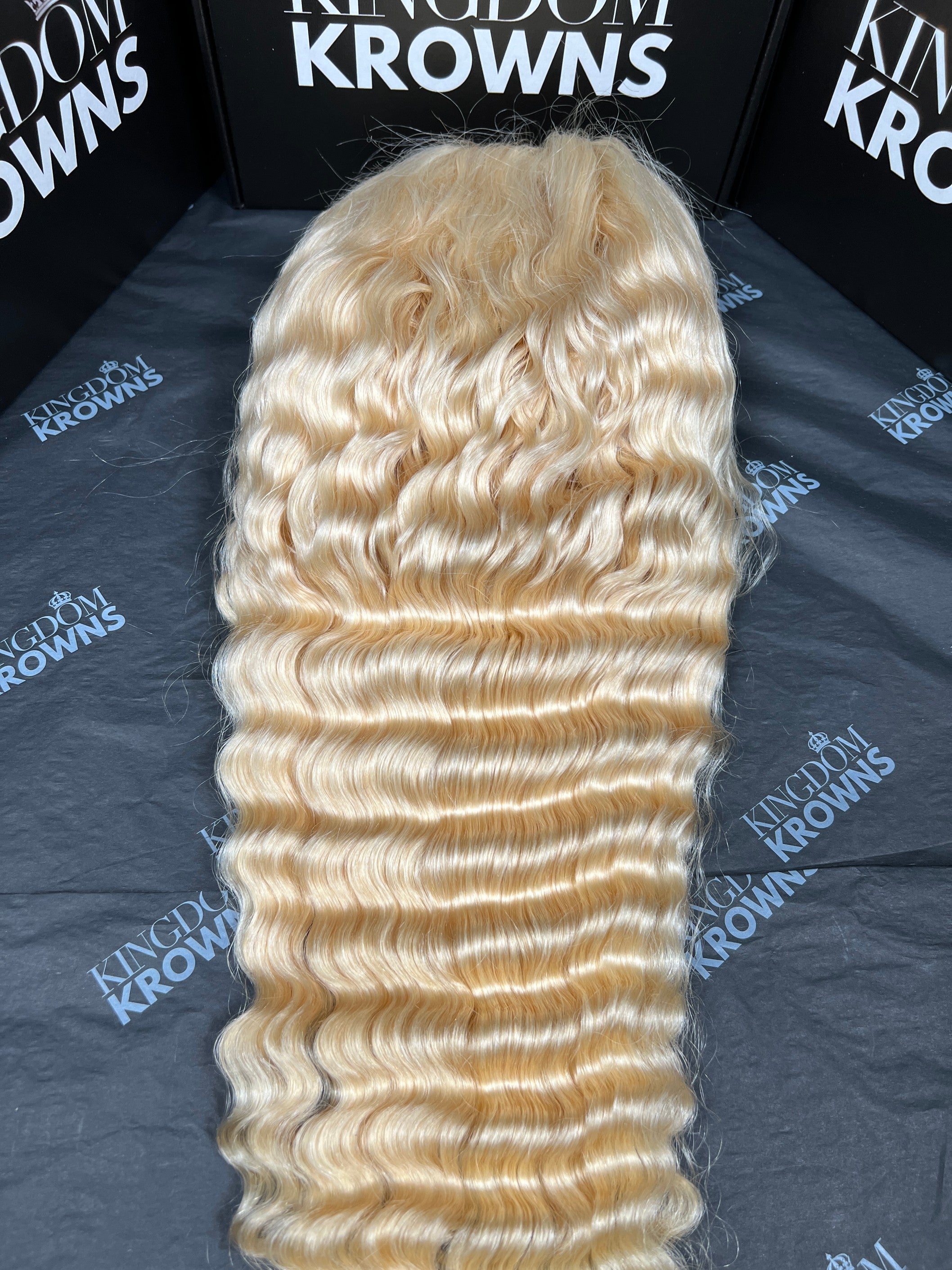 Blonde hair extensions on a branded surface
