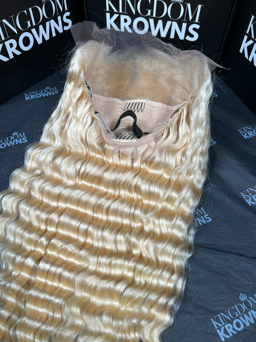 Blonde hair extensions on a black surface with 'Kingdom Krowns' branding.