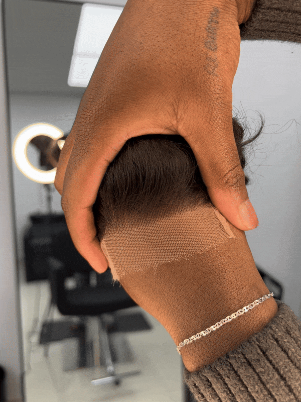 A black human hair single piece wig with body wave texture 