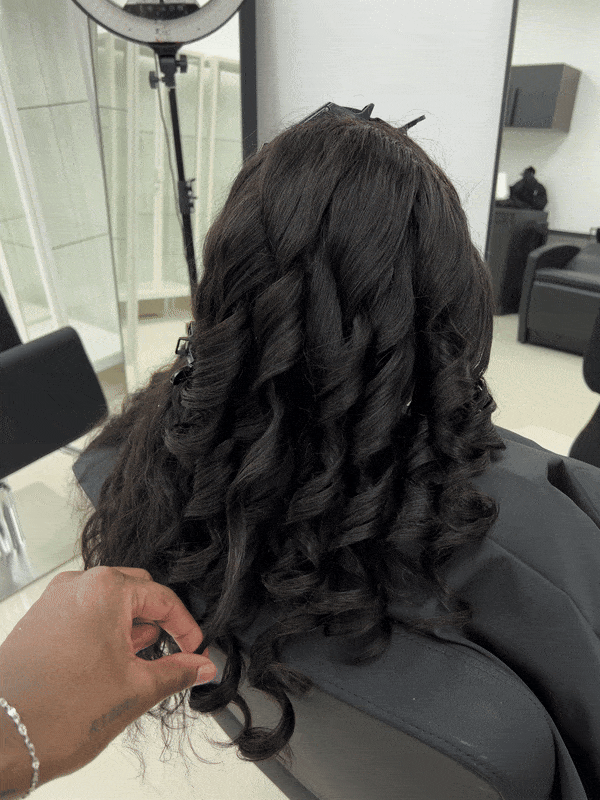 A close-up image of a natural black lace human hair wig with deep wave texture.