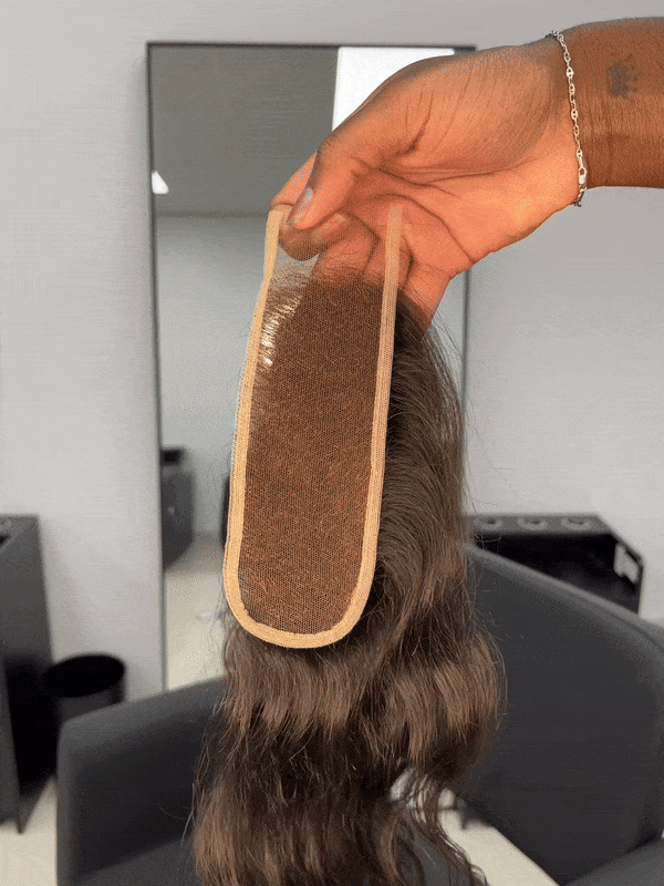 A black human hair single piece wig with body wave texture 