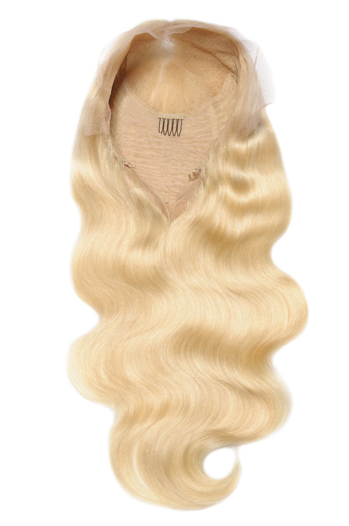 A blonde human hair wig with body wave texture on a white background.