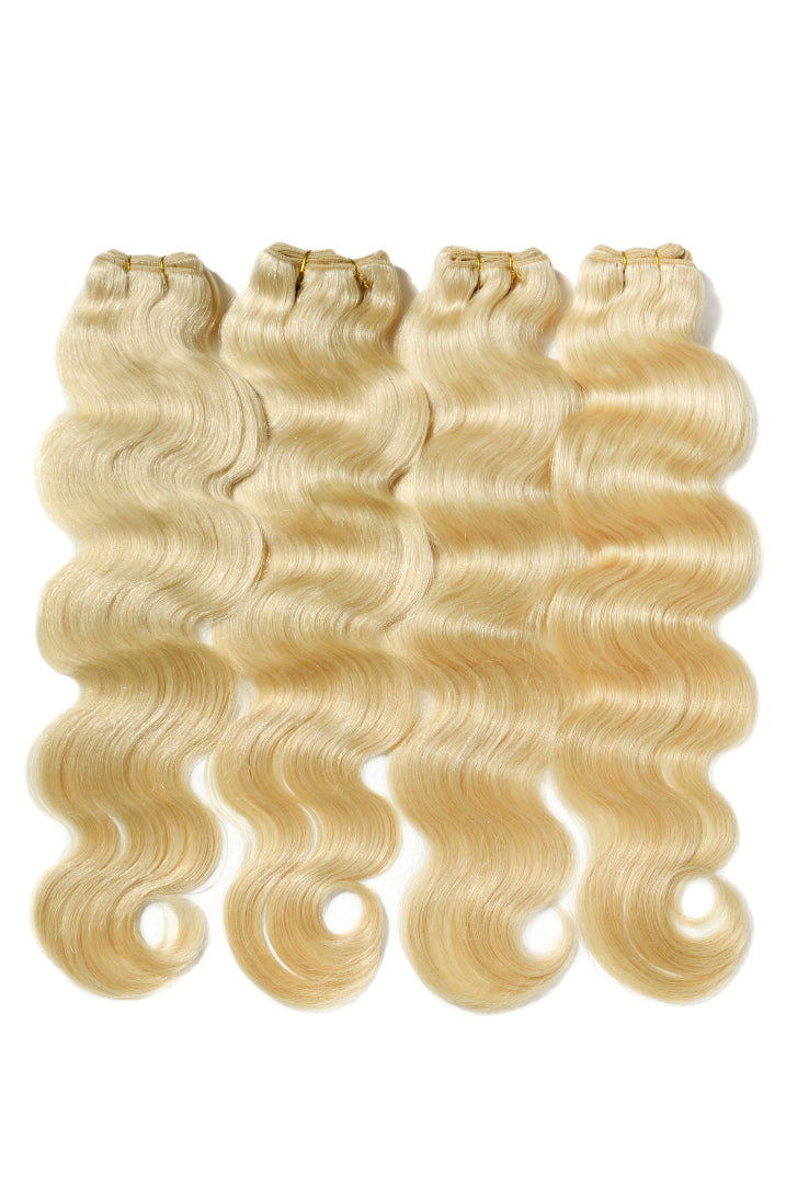 Blonde human hair extensions with body wave texture on a white background